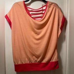 Light orange short sleeve top with dark orange trim and upper back strap detail